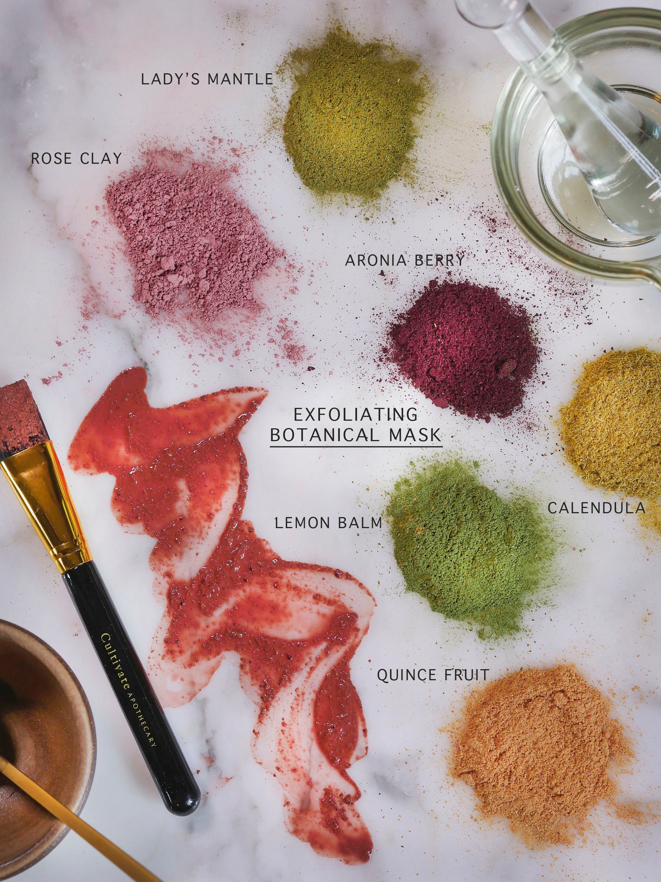 Flatlay of exfoliating botanical rose clay mask ingredients.