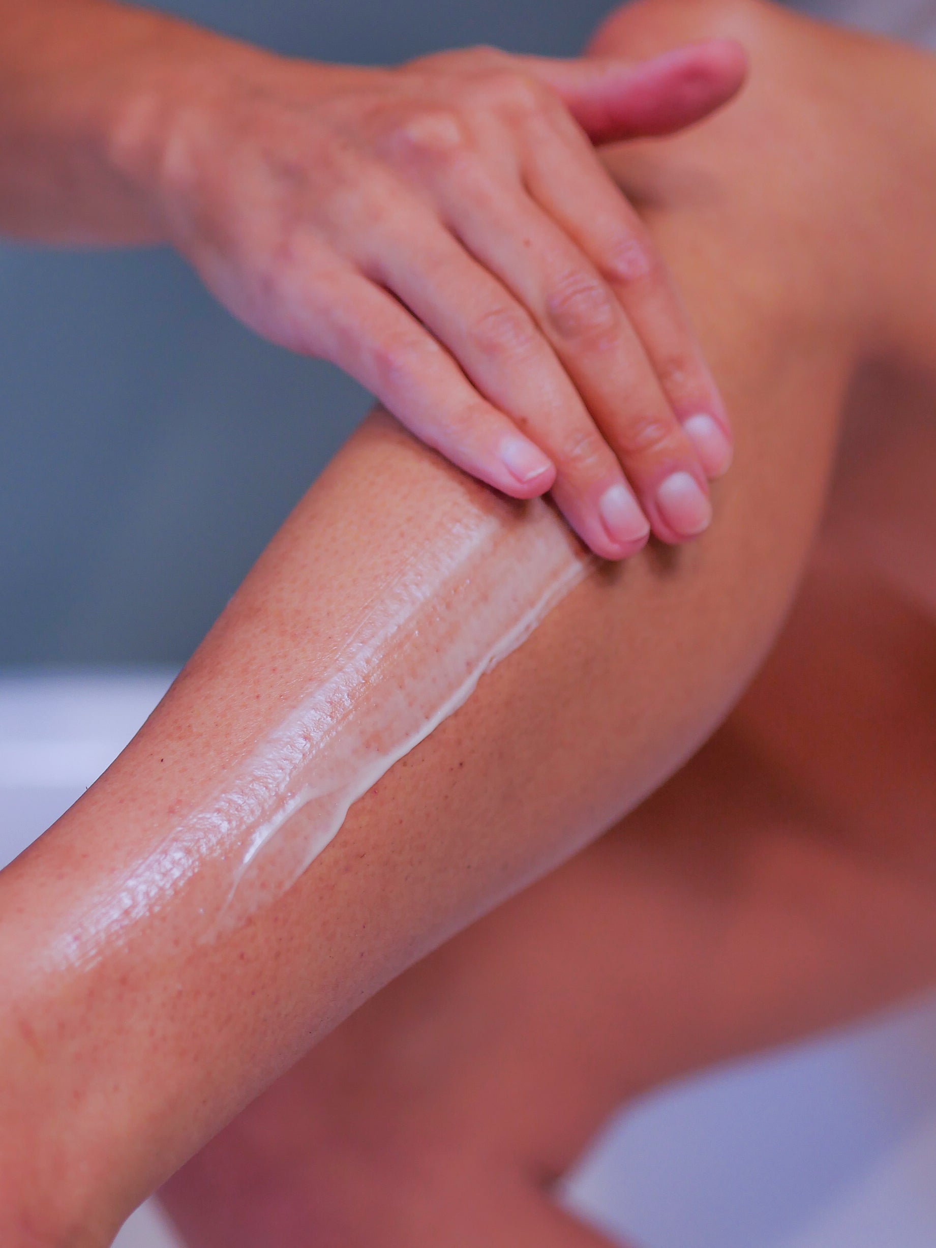 calf with body cream being applied