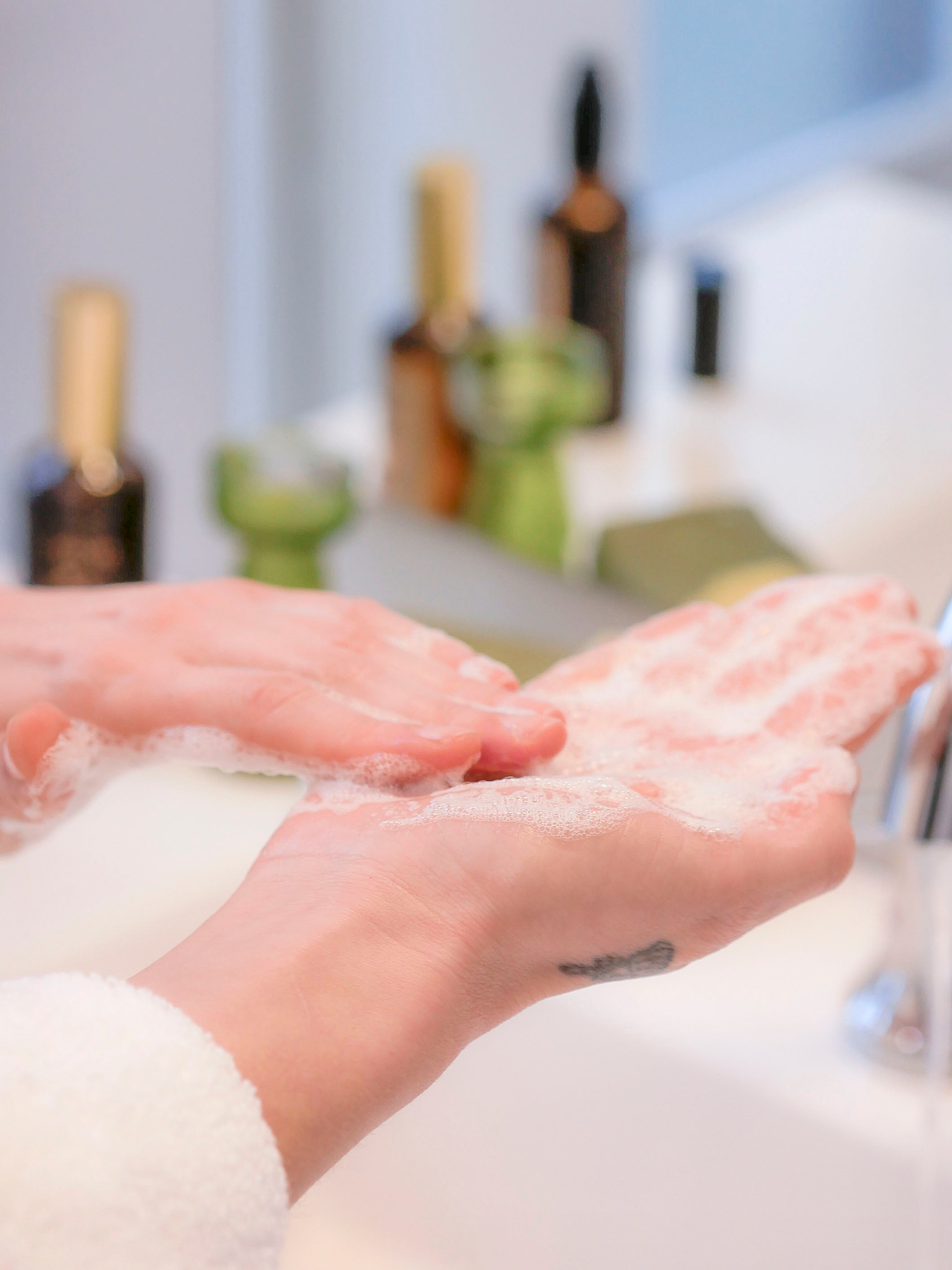 Woman using Radiance, a botanical and non-toxic facial cleanser