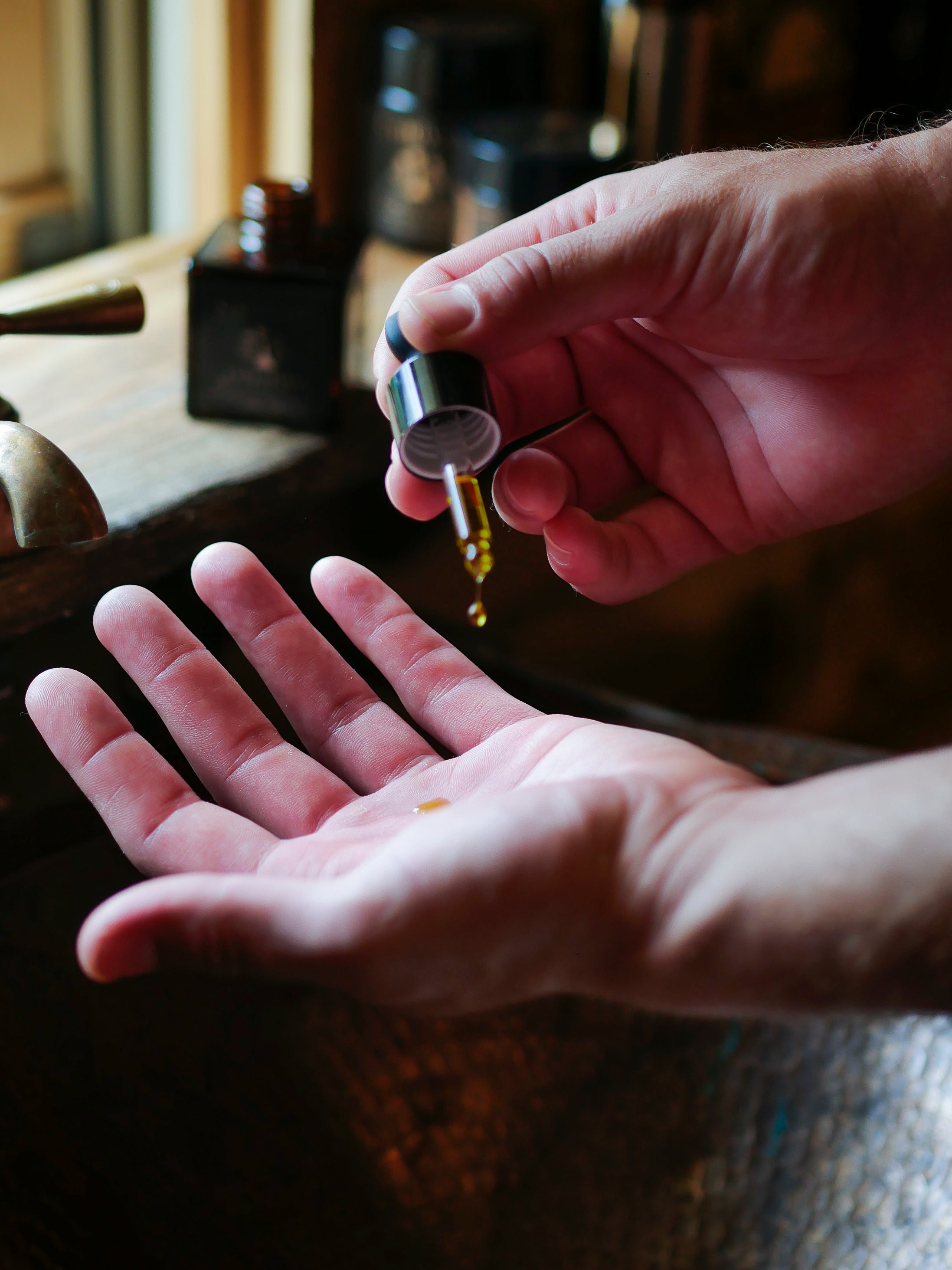 Man applying Evolution, the best face serum for men.